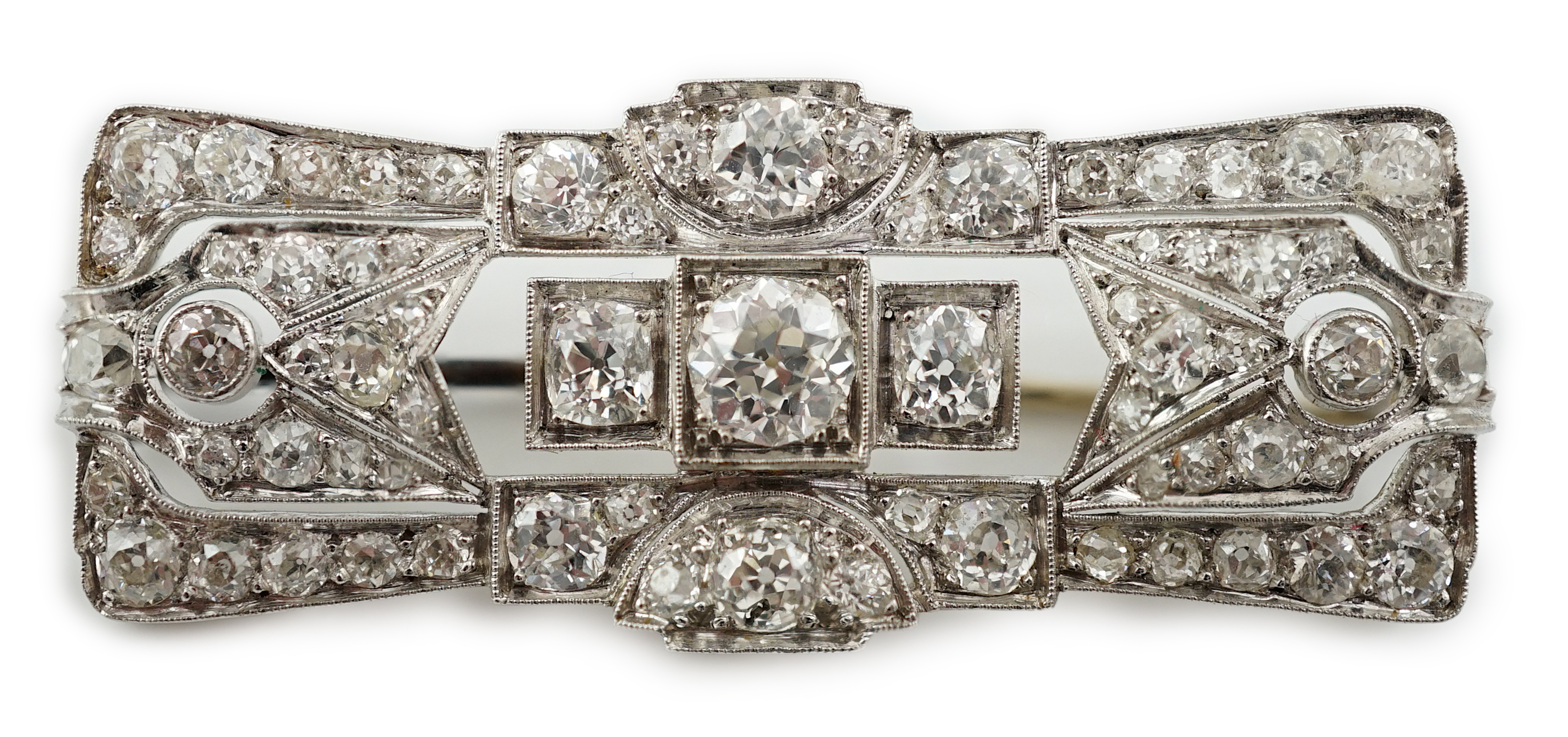 An Art Deco platinum and millegrain set diamond cluster brooch
